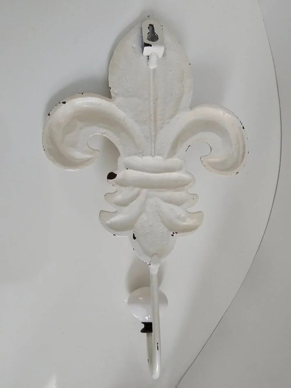 Decorative metal fleur-de-lis hook, cream colored